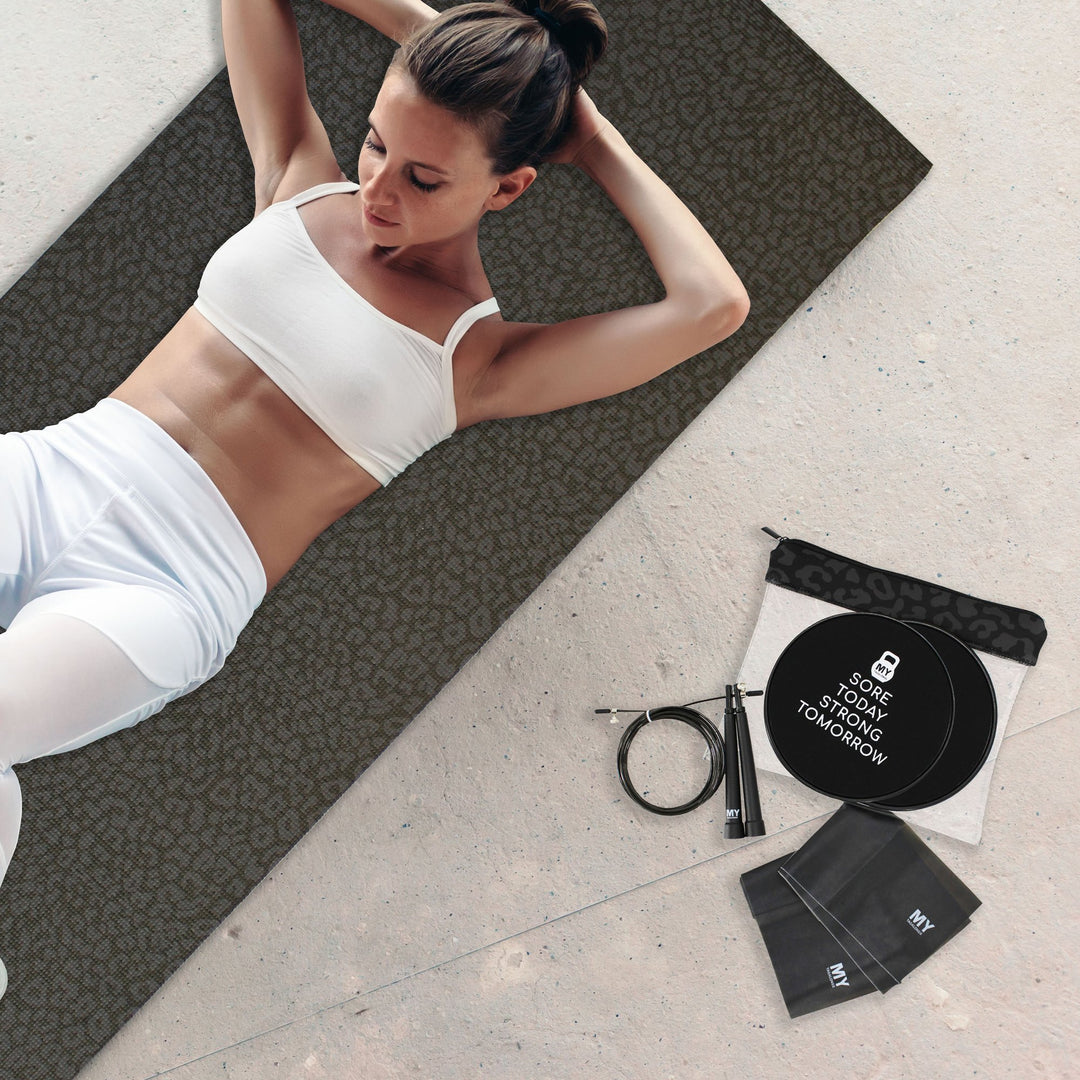 women exercising on black yoga mat